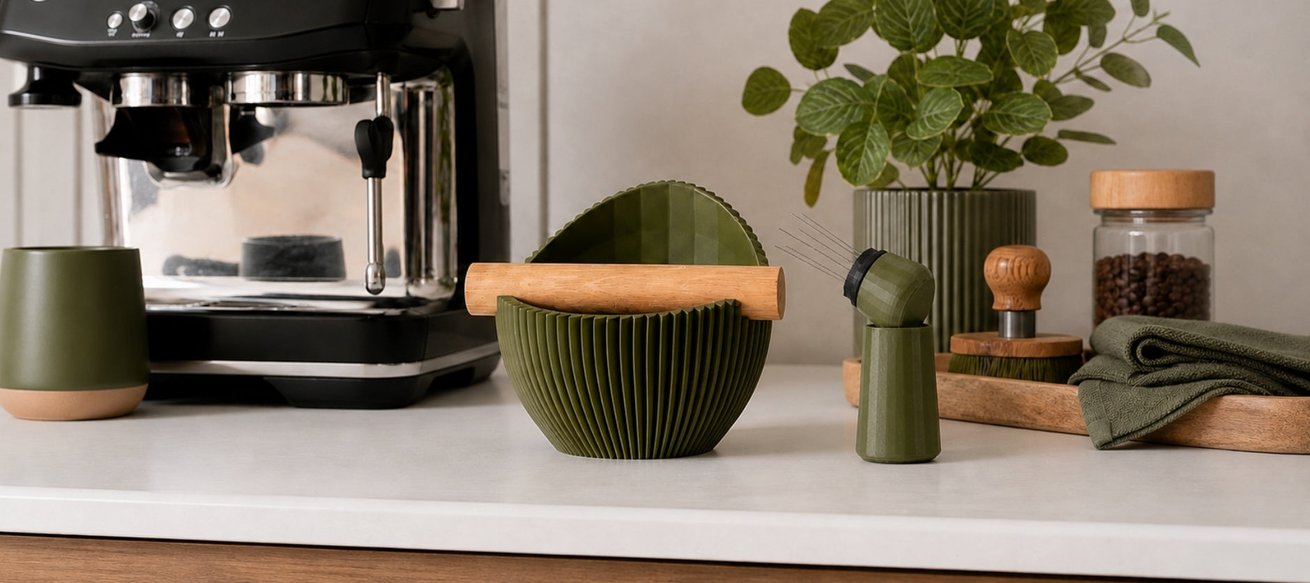 Olive green KNOCDIC Nova knock box with espresso accessories beside a Sage/Breville coffee machine