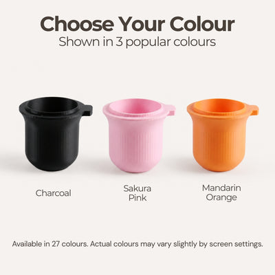 Color display chart showcasing the 54mm coffee dosing cup in pastel pink, yellow, and charcoal black.