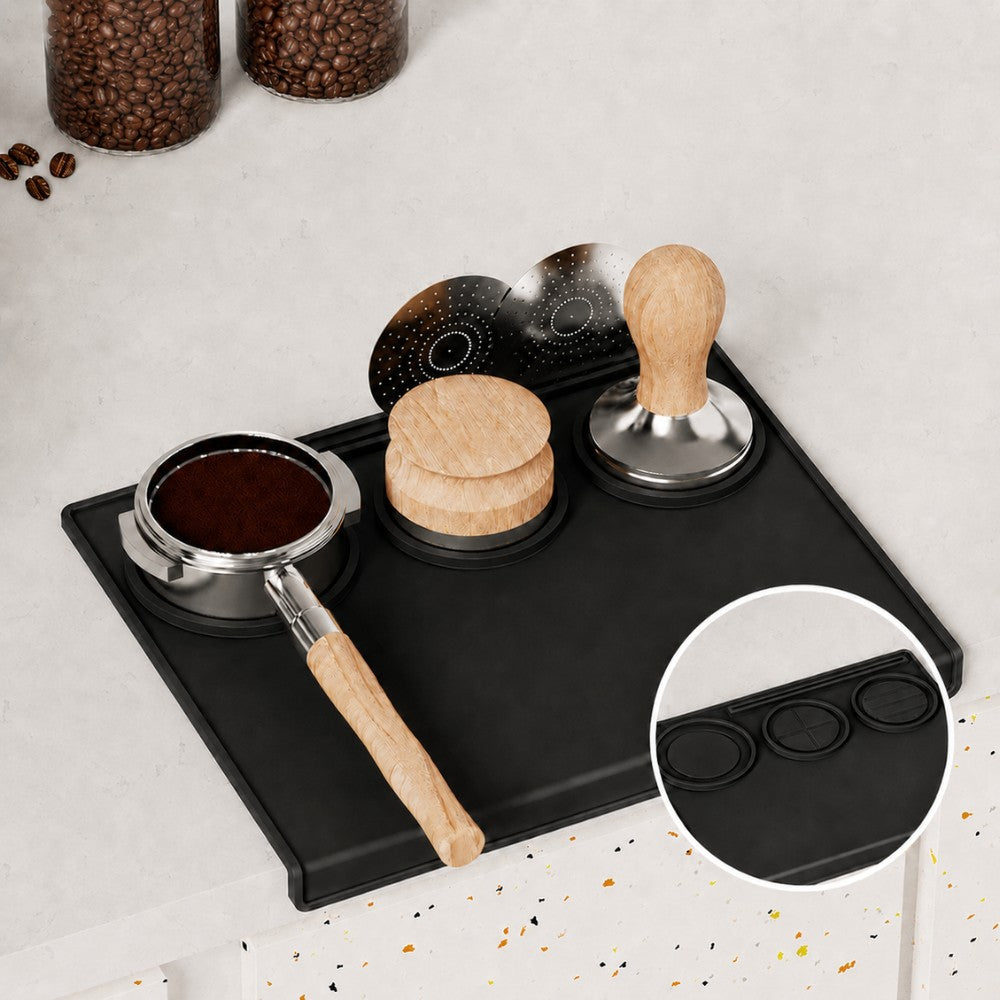 Espresso tools organised on black silicone tamping mat with portafilter and tamper