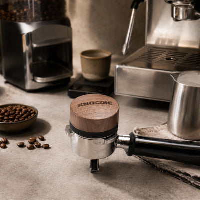 Walnut espresso distribution tool on portafilter in a home espresso coffee station setup