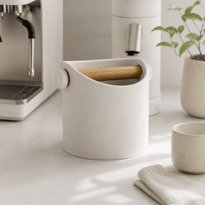 Matte off white compact coffee waste bin styled beautifully next to a premium home espresso machine setup.