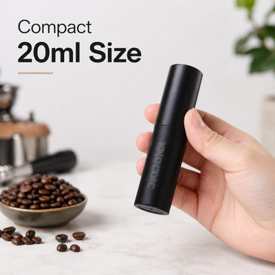 Compact 20ml coffee bean spray bottle beside espresso grinder and coffee tools