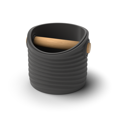 Ripple round espresso knock box with a Charcoal rippled shell, a lift-out Charcoal inner bin and a solid oak knock bar with Knock Caps