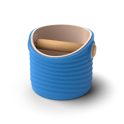 Ripple round espresso knock box with a Marine Blue rippled shell, a lift-out Latte Brown inner bin and a solid oak knock bar with Knock Caps