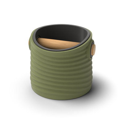 Ripple tapered round espresso knock box with an Olive Green rippled shell, a lift-out Charcoal inner bin and a solid oak knock bar with Knock Caps