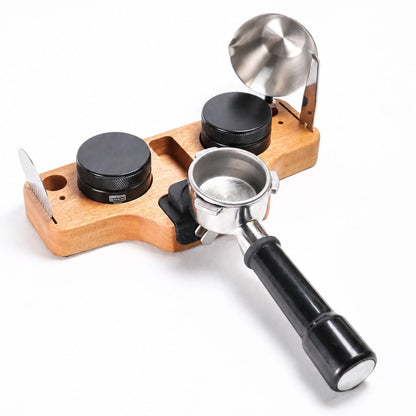 Coffee tamp with wooden base and metal components on a white background