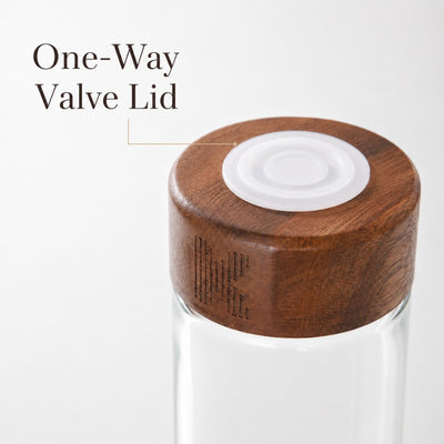 One-way valve lid on glass coffee bean storage tube