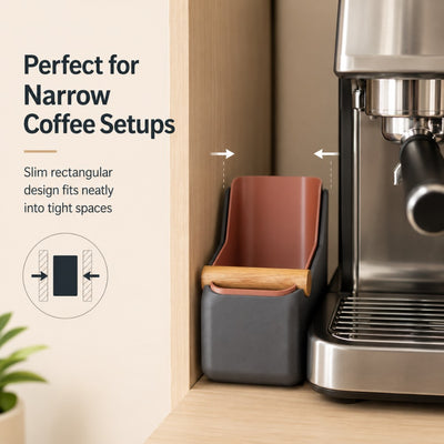 A slim charcoal grey curved espresso knock box tucked neatly into a narrow gap on a kitchen counter coffee bar.