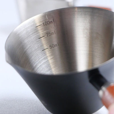 Stainless steel espresso measuring cup with internal markings