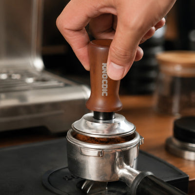 KNOCDIC espresso tamper pressing coffee grounds in a portafilter