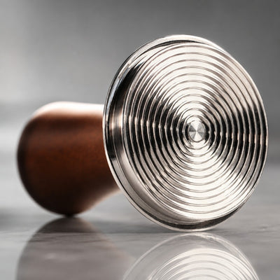 Close up of stainless steel grooved espresso tamper base