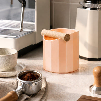 A minimalist geometric espresso knock box beautifully styled on a modern clean kitchen coffee station countertop.