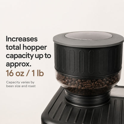 Coffee grinder with coffee beans and text about increased hopper capacity.