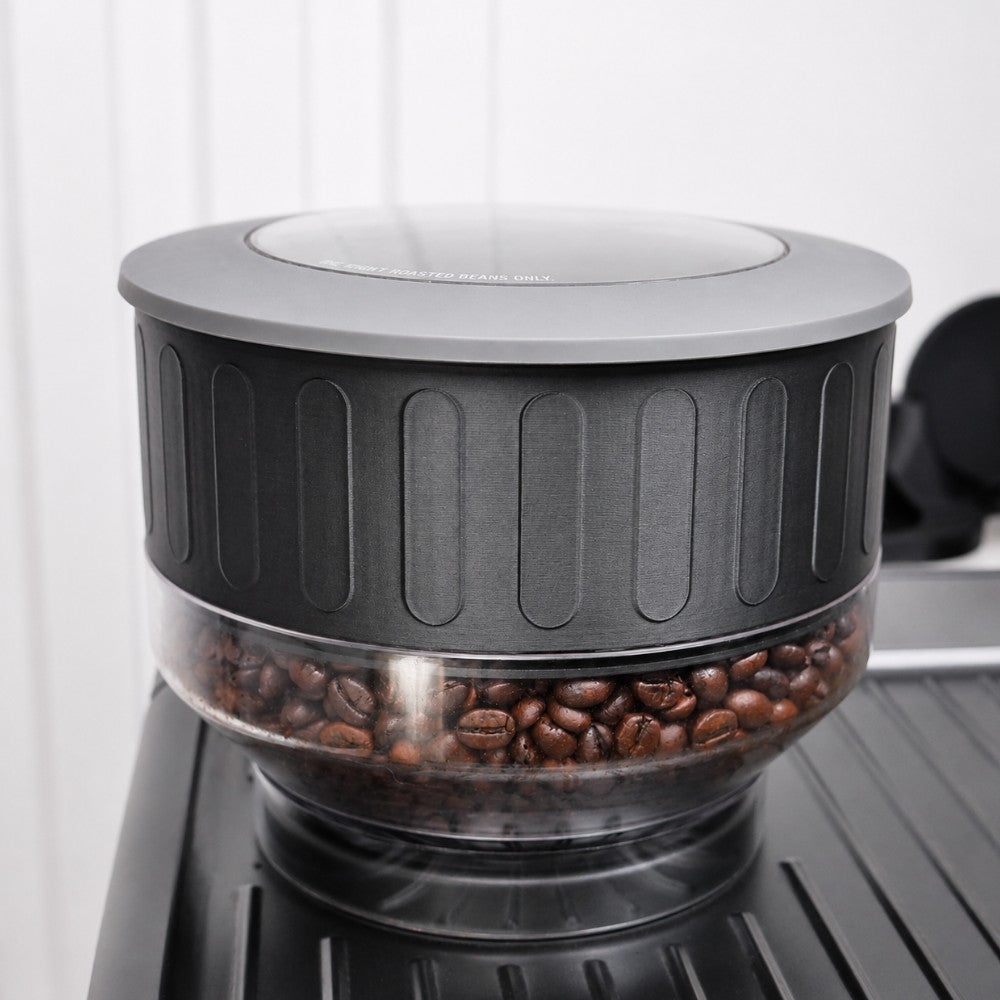 Coffee grinder and hooper extender  with coffee beans inside on a white background