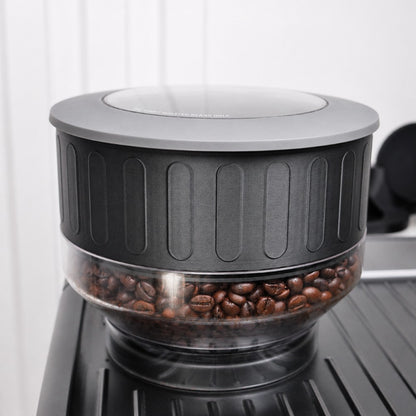 Coffee grinder and hooper extender  with coffee beans inside on a white background