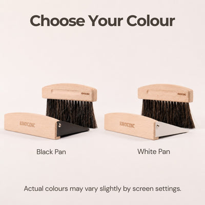 Two wooden brushes with black and white pans on a light beige background.