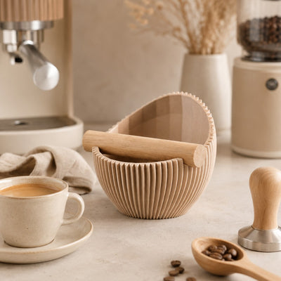 A latte brown customizable coffee knock box beautifully styled on a modern kitchen counter with ceramic mugs.