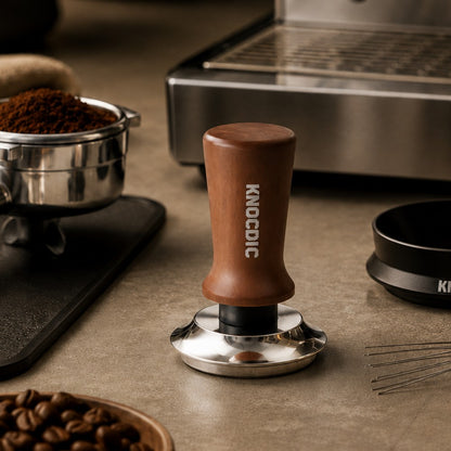 Espresso tamper beside portafilter dosing funnel WDT tool puck screen and coffee beans
