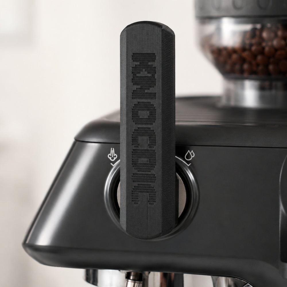 KNOCDIC matte black ergonomic steam lever attachment mounted onto the side dial of a Sage Barista Pro.