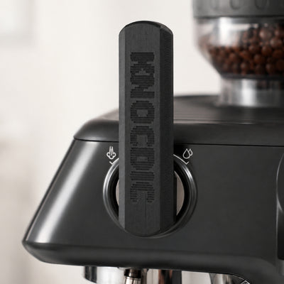 KNOCDIC matte black ergonomic steam lever attachment mounted onto the side dial of a Sage Barista Pro.