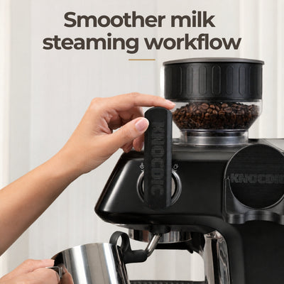 A home barista using an extended custom lever to smoothly activate the steam wand on a Barista Pro espresso machine.